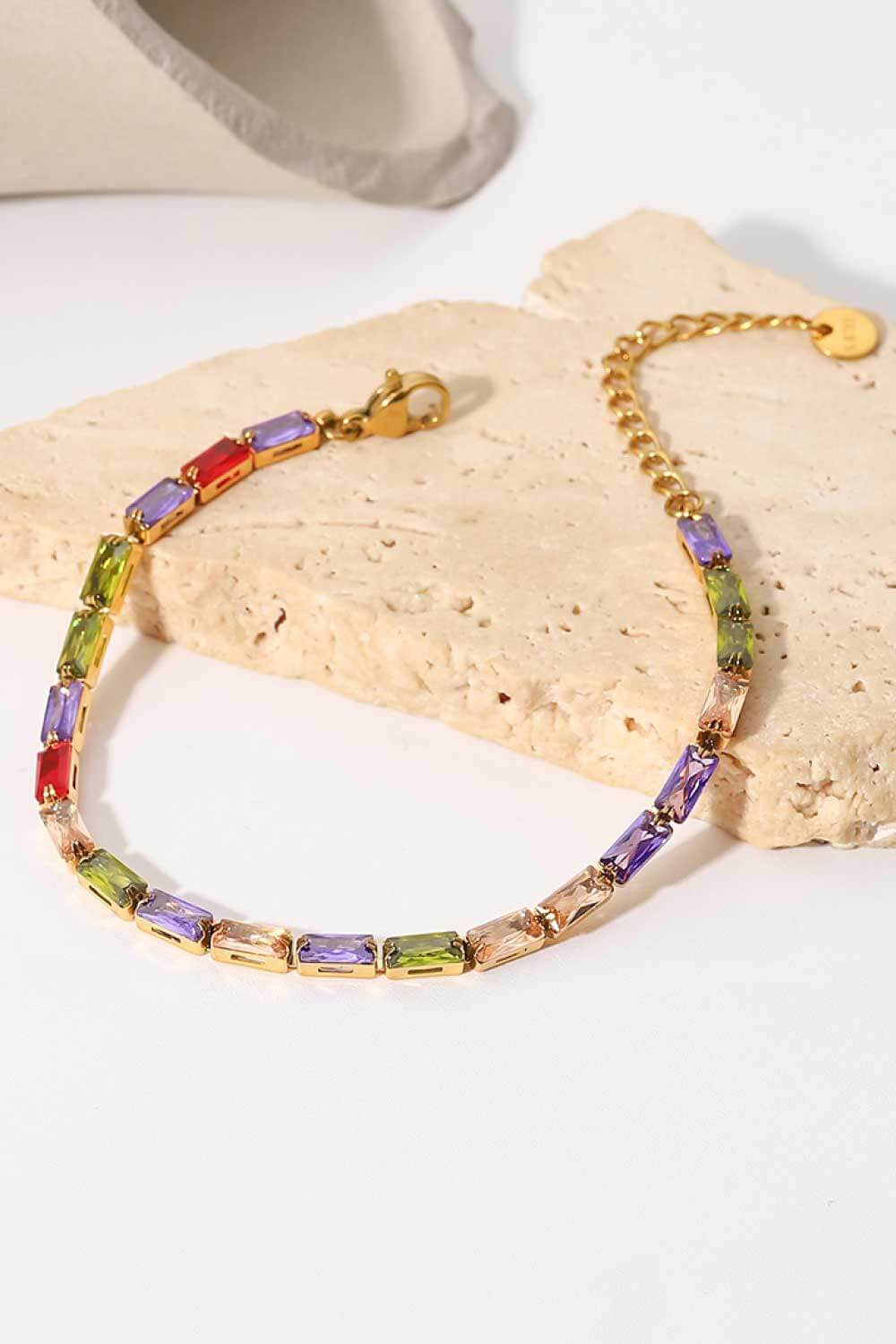 Gold-plated cubic zirconia bracelet with multicolored rectangular stones and dangling chain