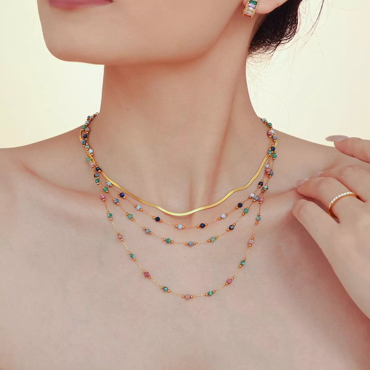 Gold-plated necklace with multicolor bead strands and round center clasp