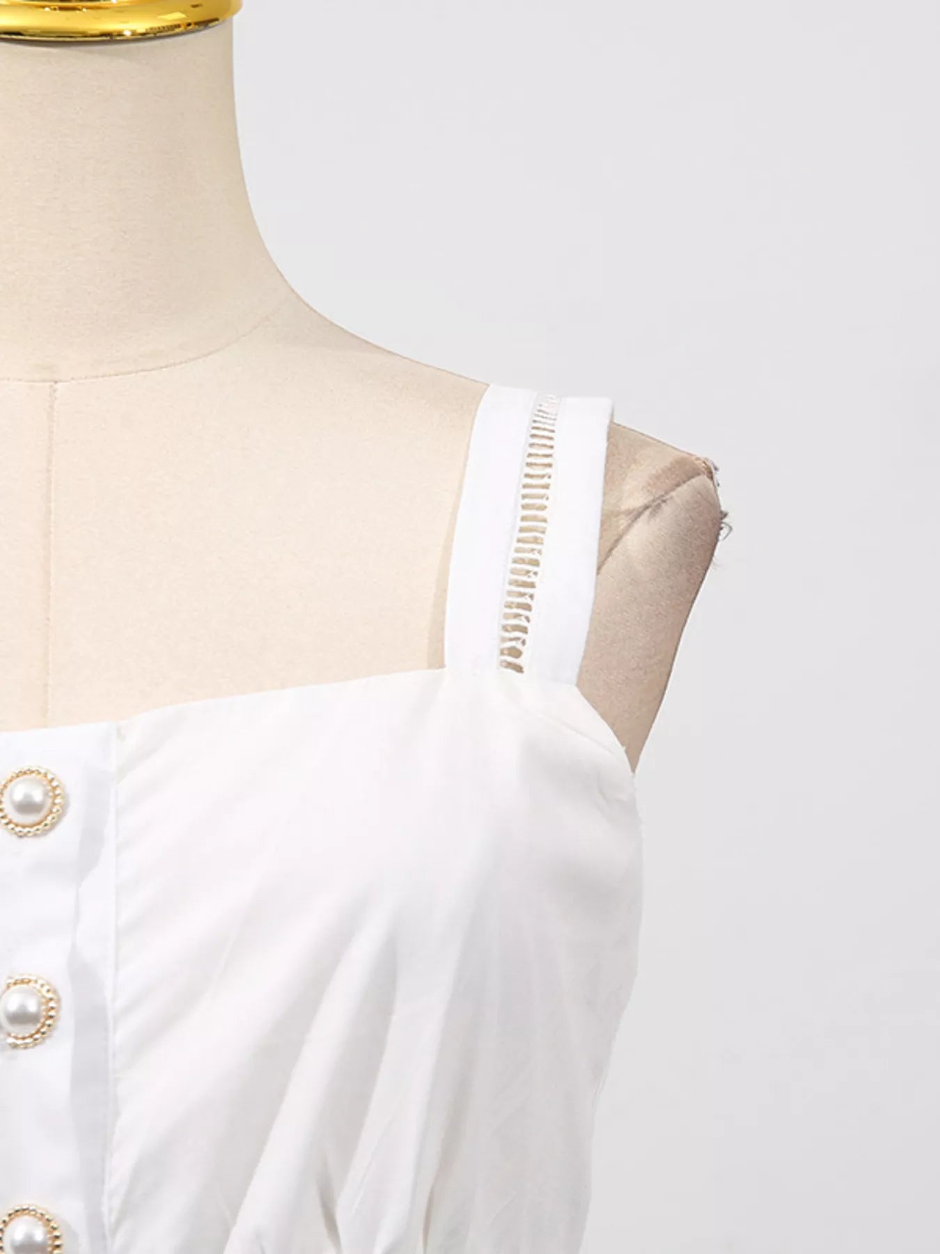 Cedar & Moore sleeveless eyelet button-down white midi dress with pearl buttons and gold chain strap.