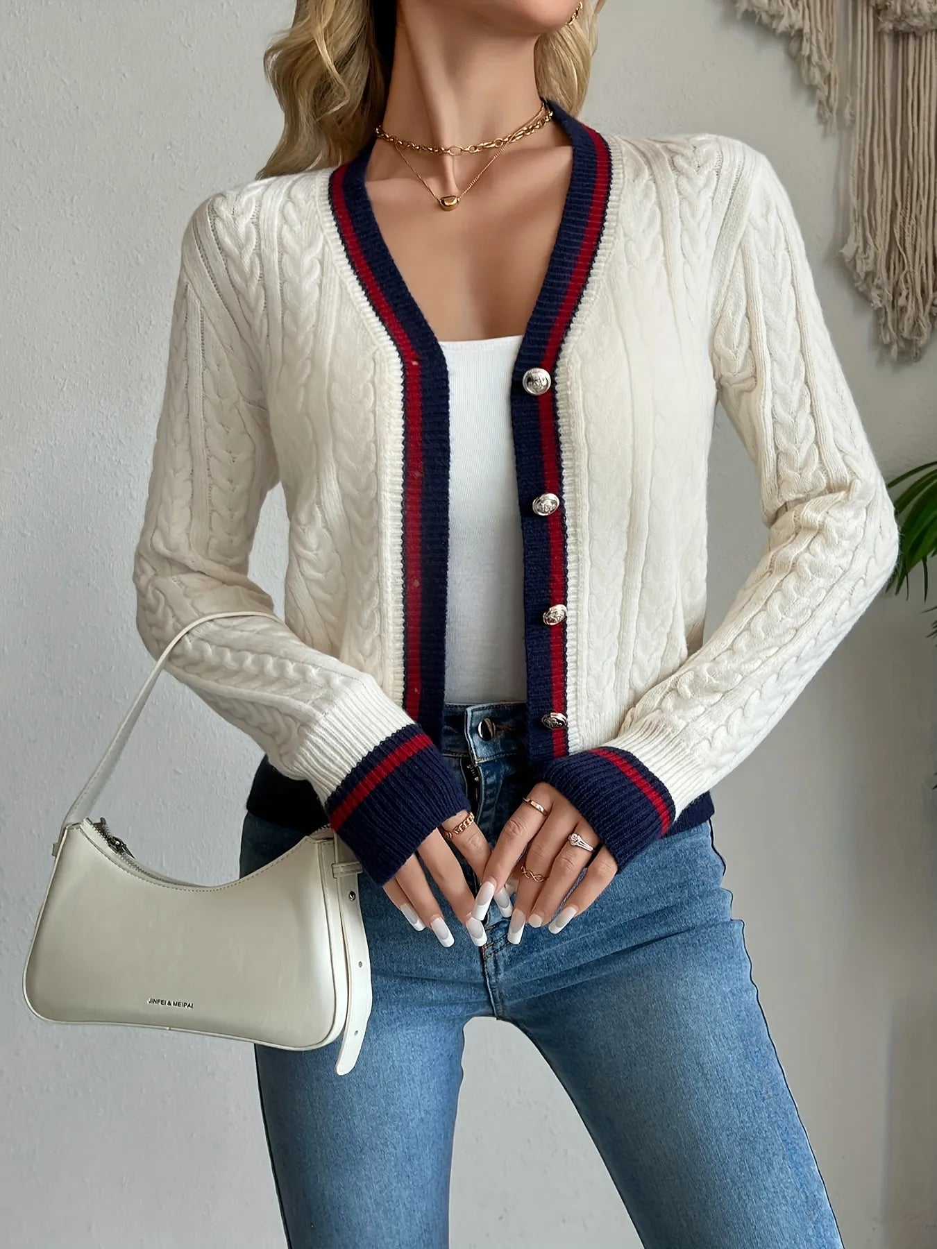 Ivory cable-knit button-front cardigan with navy and red striped trim