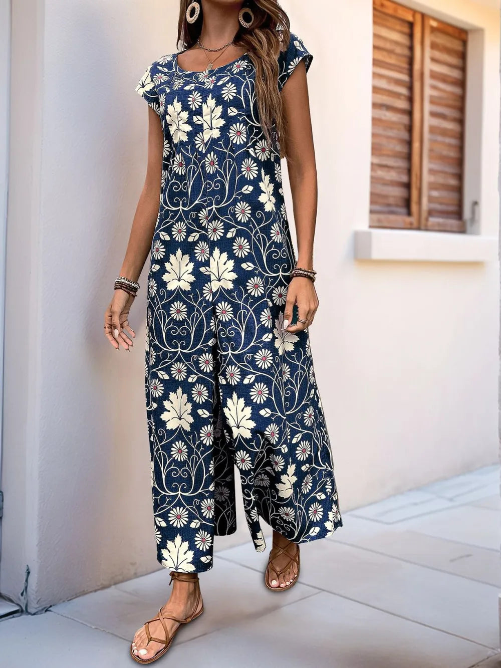 Navy floral printed wide-leg jumpsuit with round neck and cap sleeves, full front view