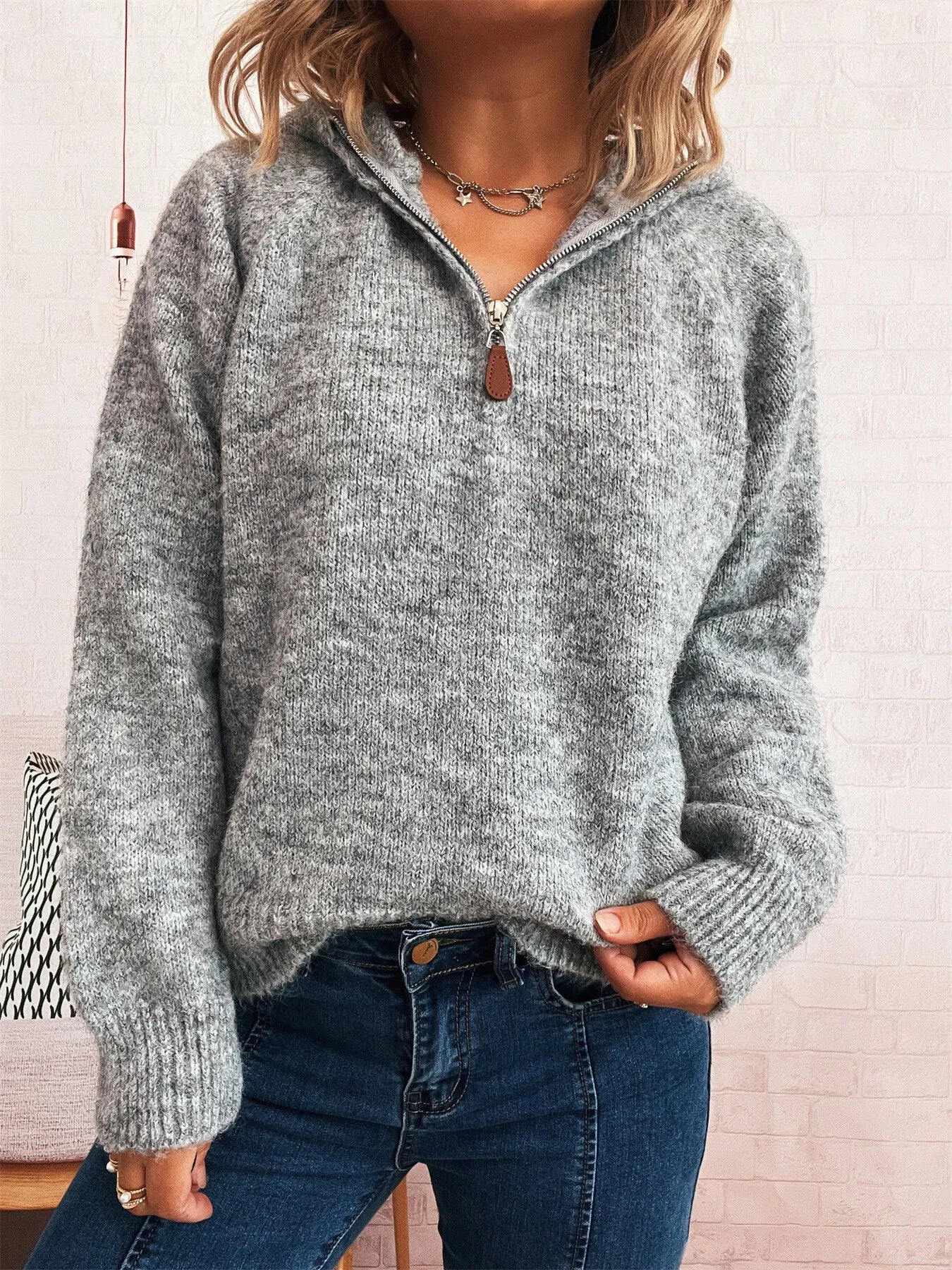 Dark gray quarter-zip sweater with ribbed cuffs and hem