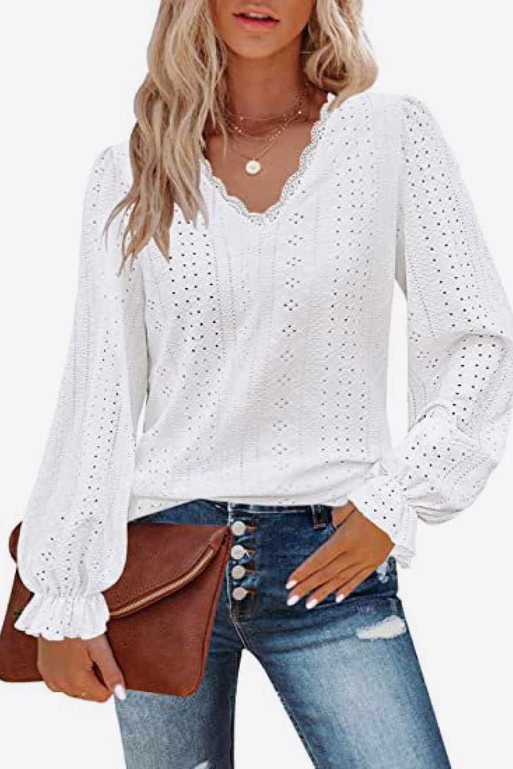 White eyelet V-neck blouse with flounce cuffs and long puff sleeves