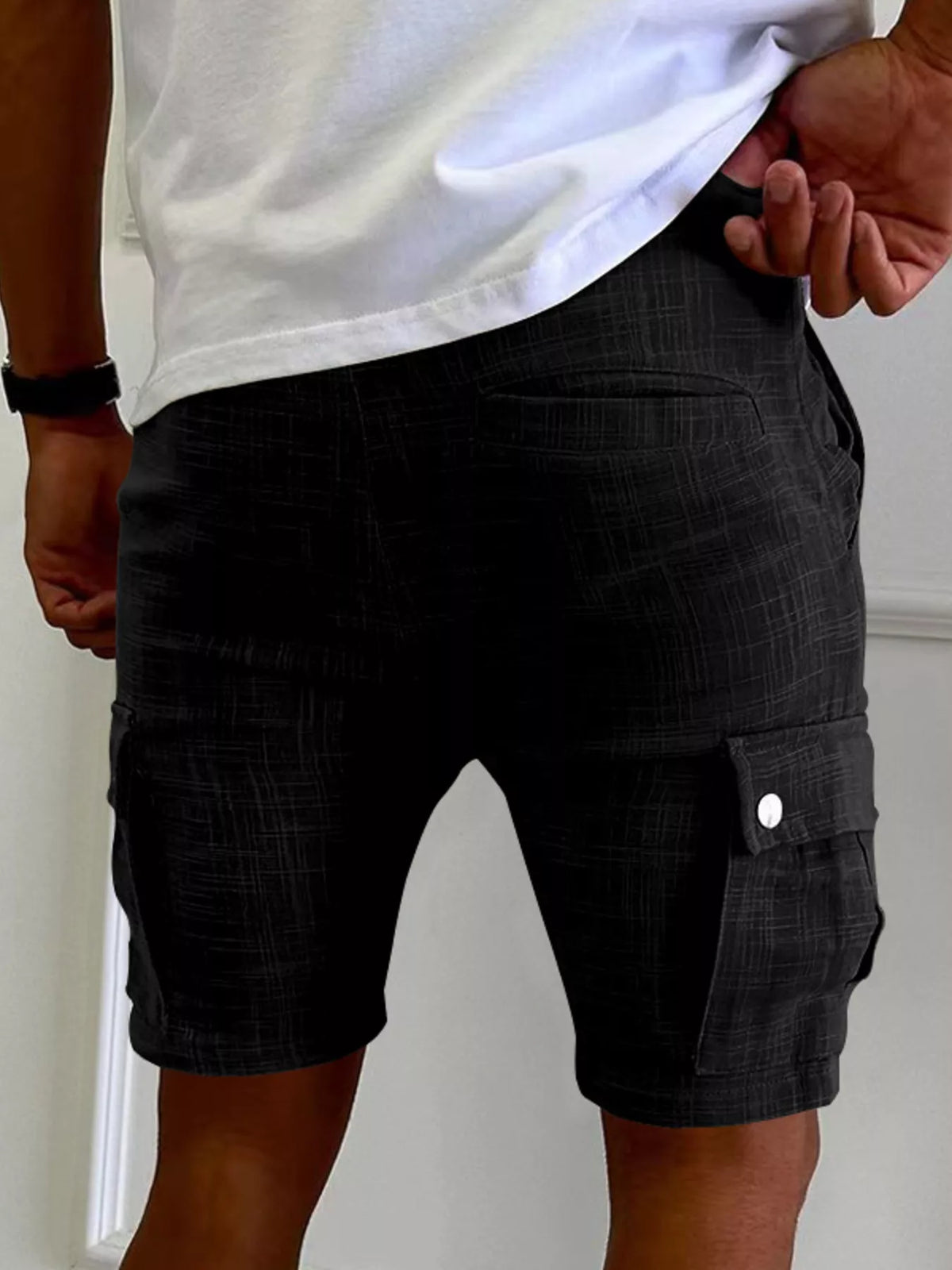Men's black cargo shorts with cargo pocket and snap-button flap detail