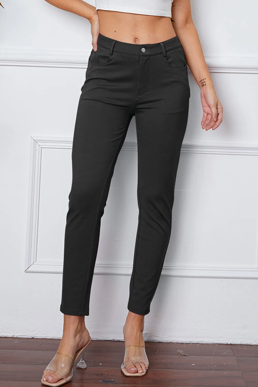 Black slim ankle pants with belt loops, front button closure, and side pockets