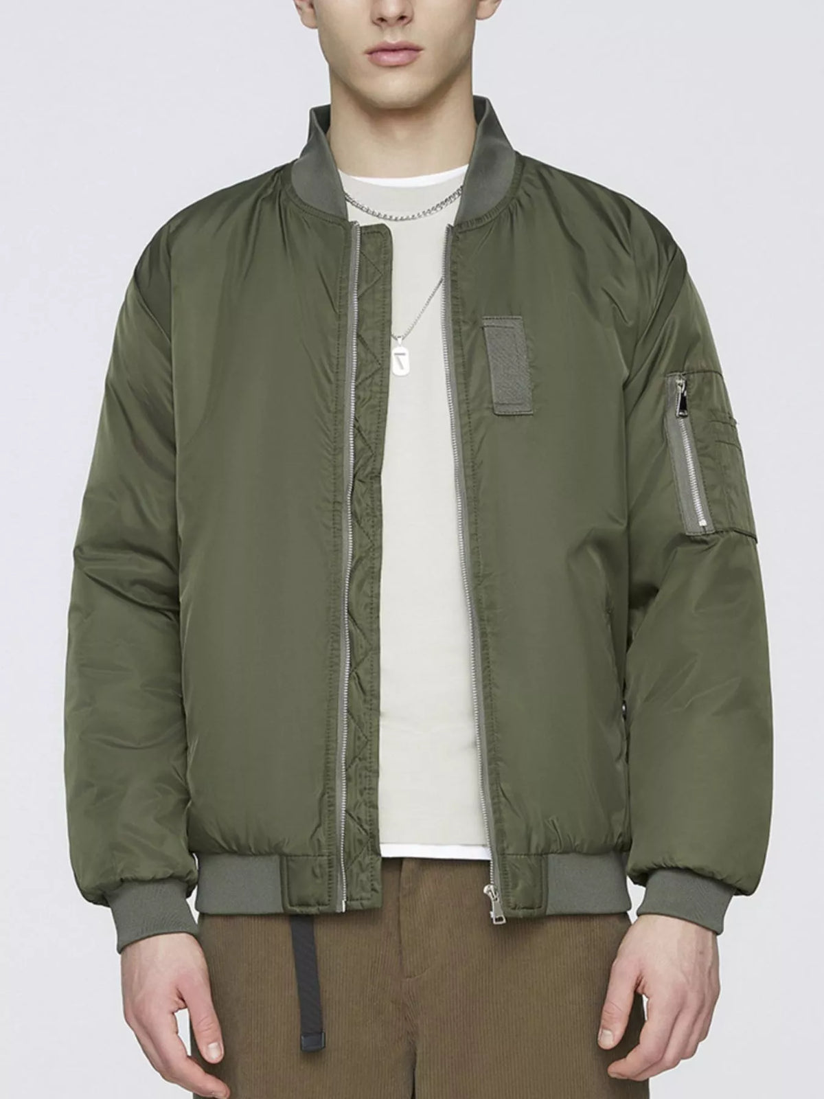 Lightweight military green bomber jacket with stand collar, zip front and sleeve pocket