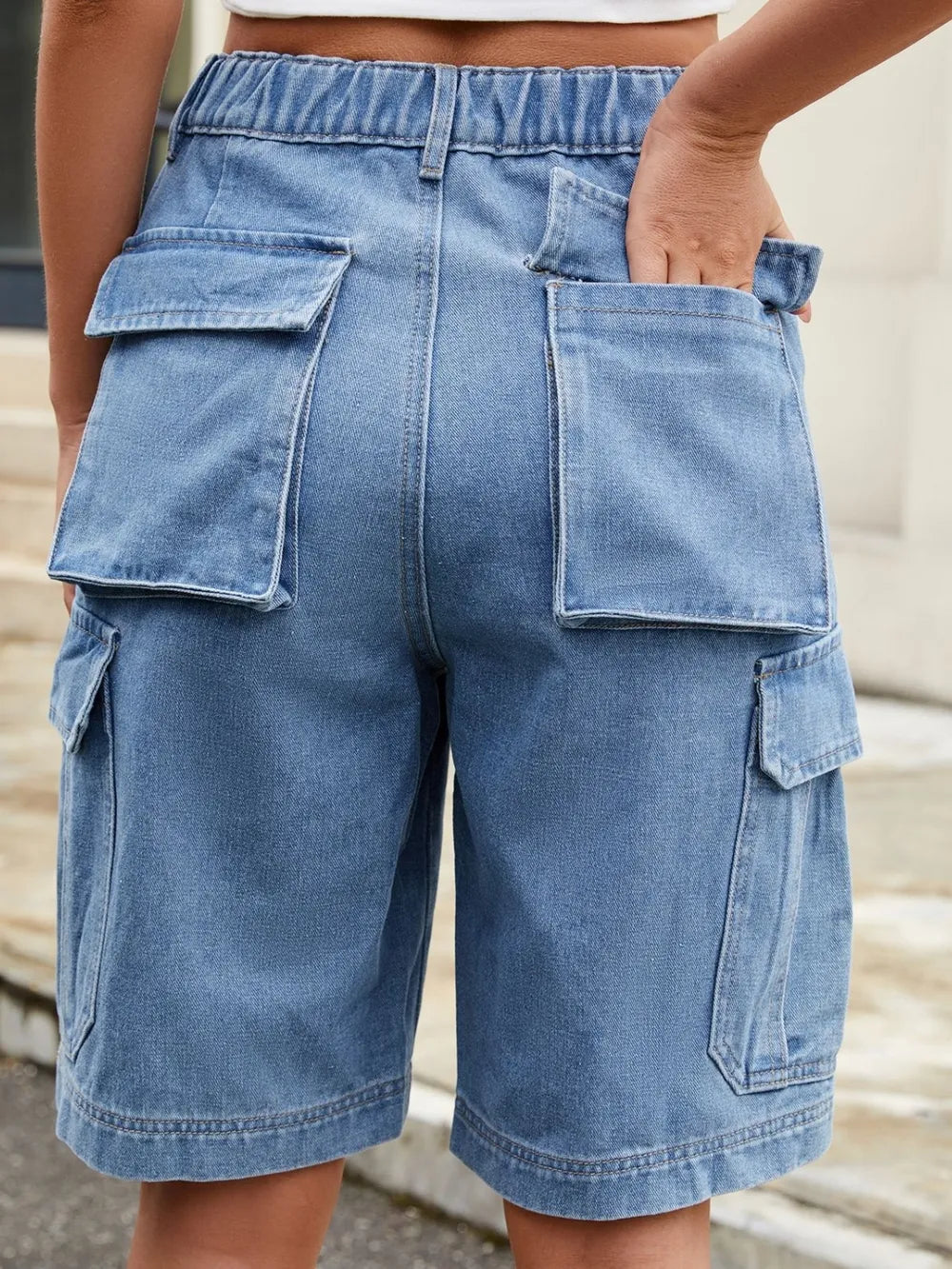 High waist denim shorts in medium blue with front slash pockets and cargo pockets