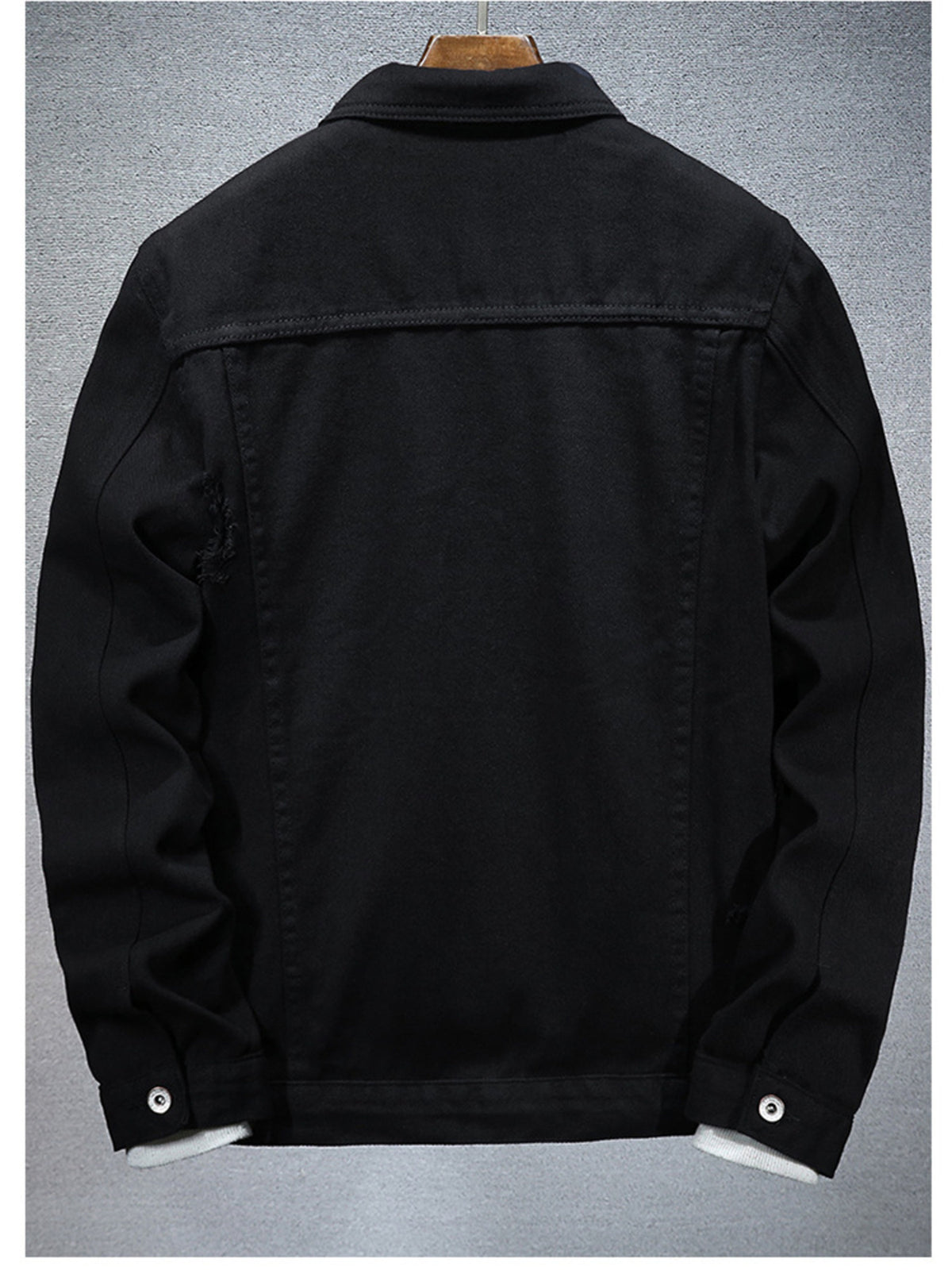Black distressed denim jacket, slim fit, back view, button cuffs and yoke seams