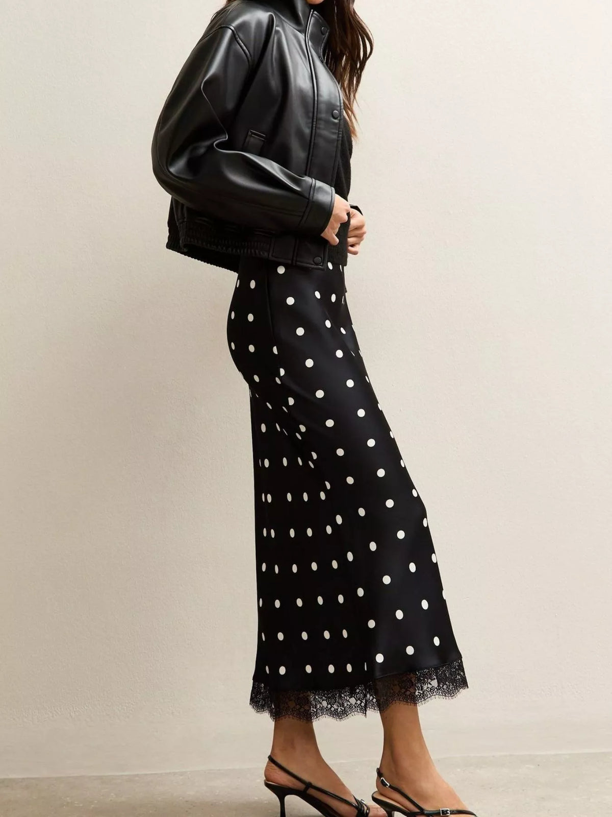 Black midi skirt with white polka dots and scalloped lace hem detail