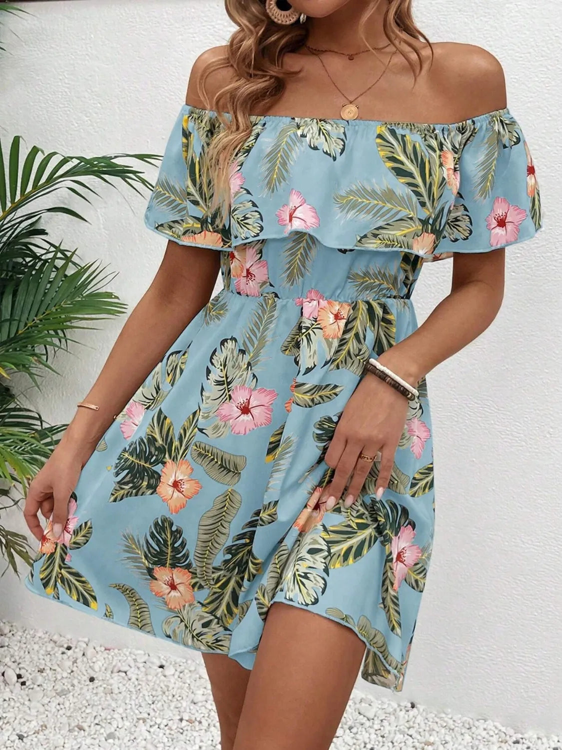 Printed off-shoulder ruffled mini dress in blue tropical hibiscus print by Trendsi