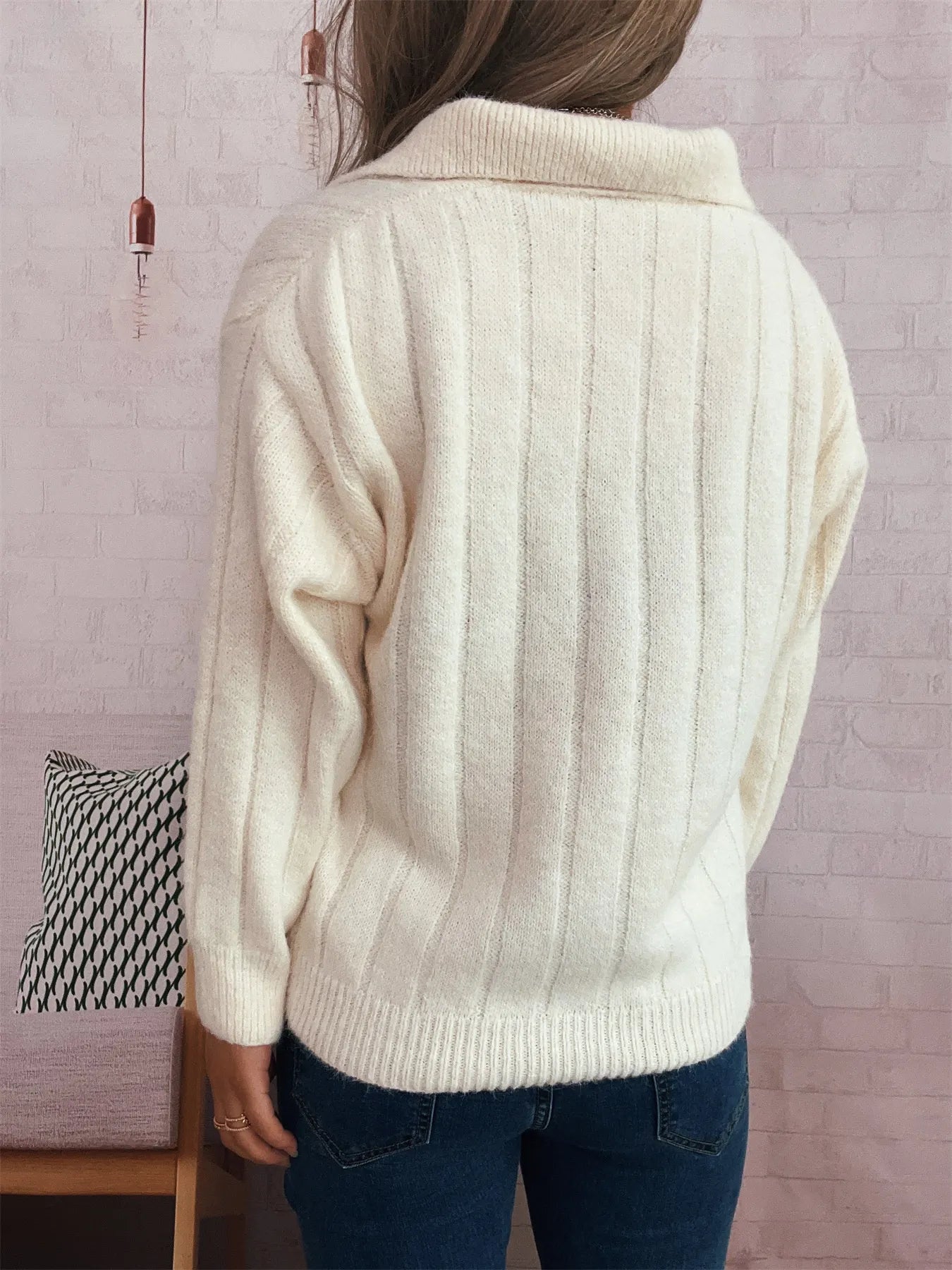Ribbed hem quarter zip sweater in cream white, back view with ribbed collar and knit texture.