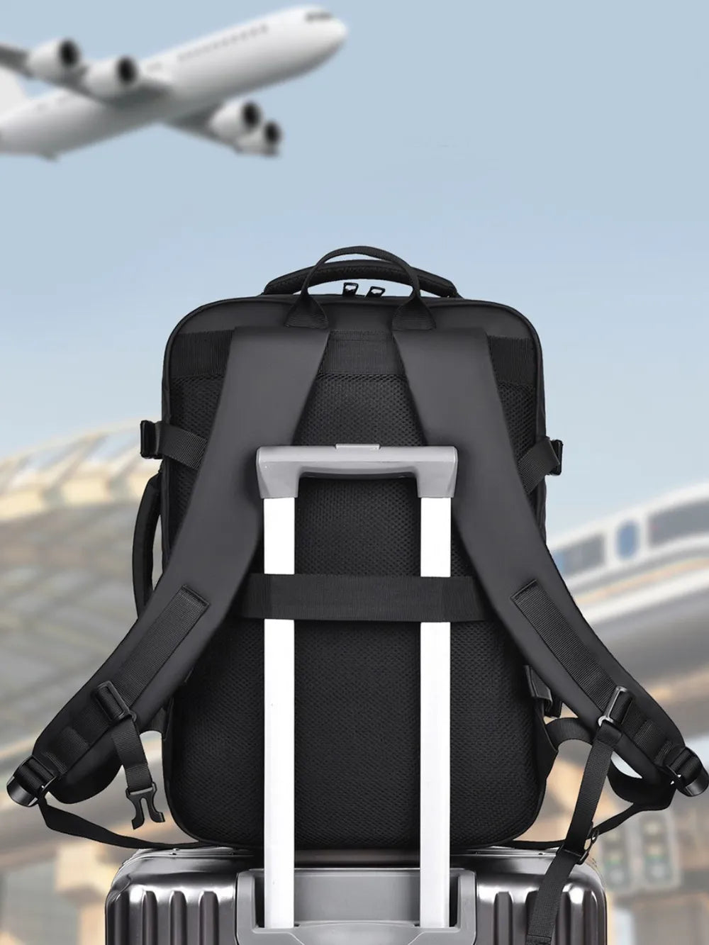 Black backpack with top handle, padded shoulder straps, and webbing support frame.