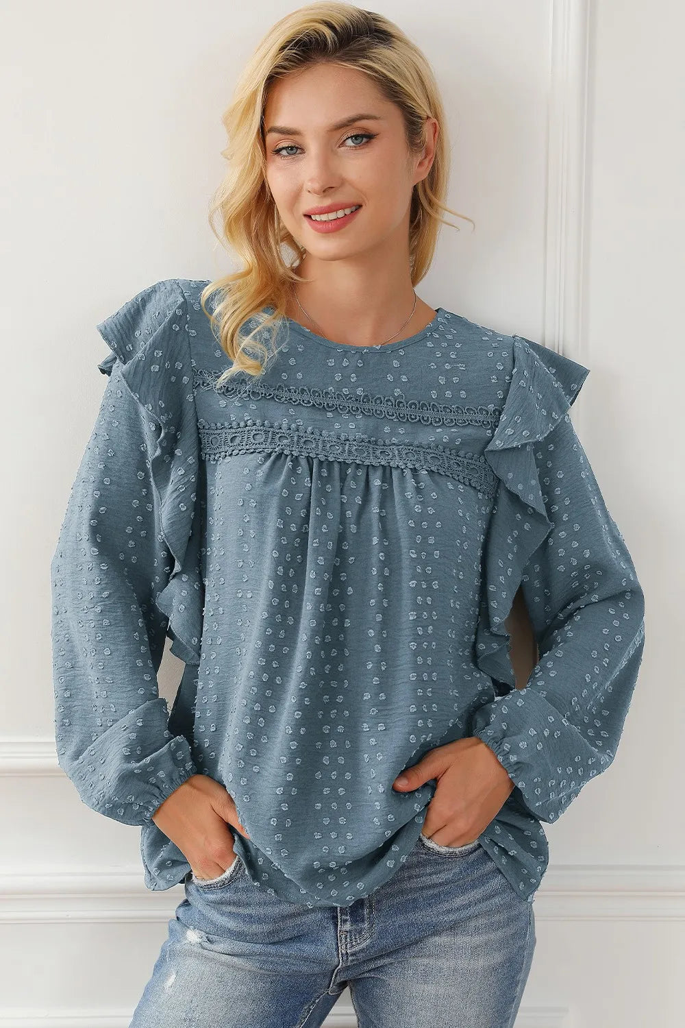 Blue round-neck ruffled blouse with long puff sleeves and dot pattern