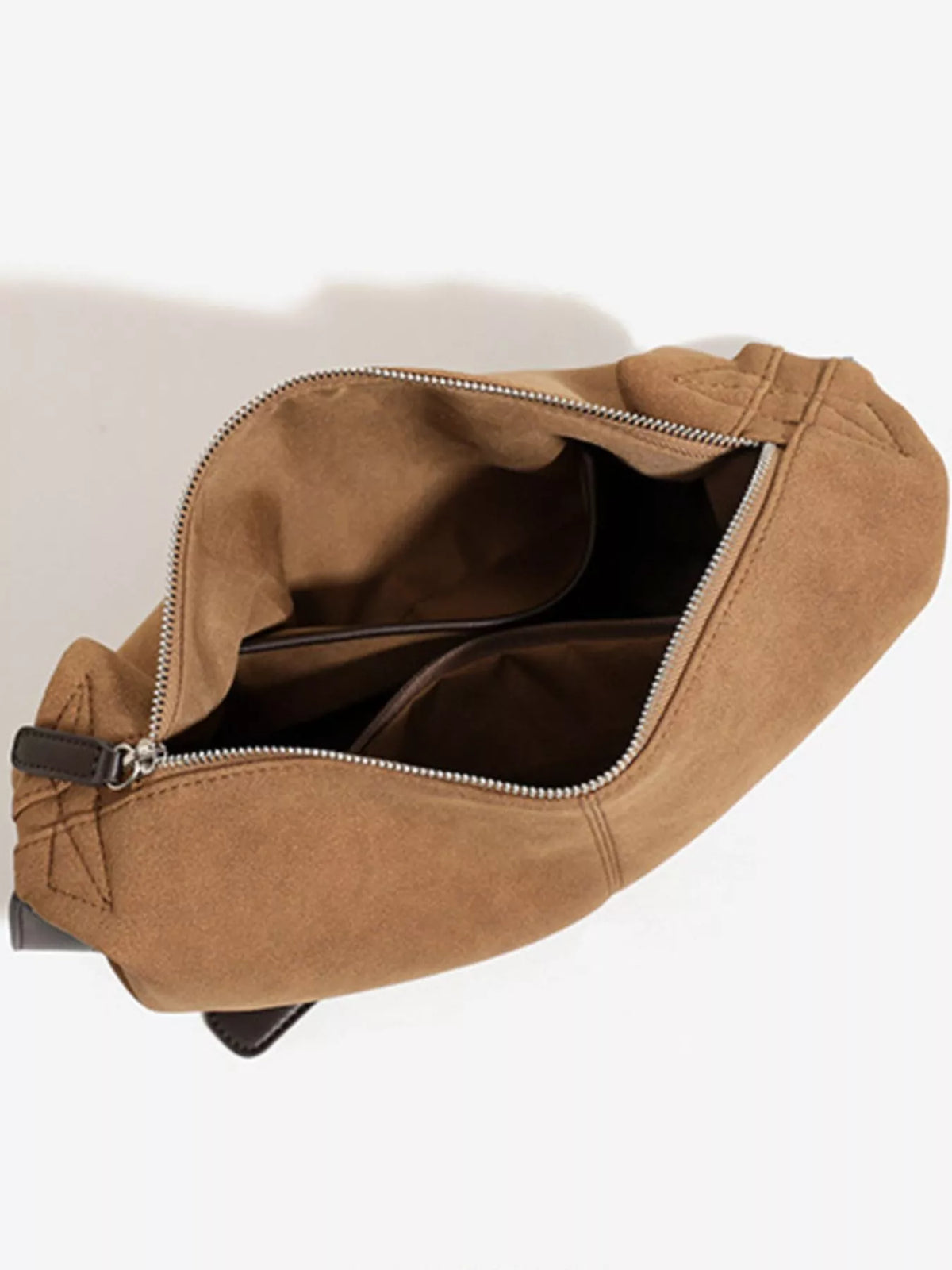Brown suede crescent shoulder bag interior view with top zipper and lined pocket