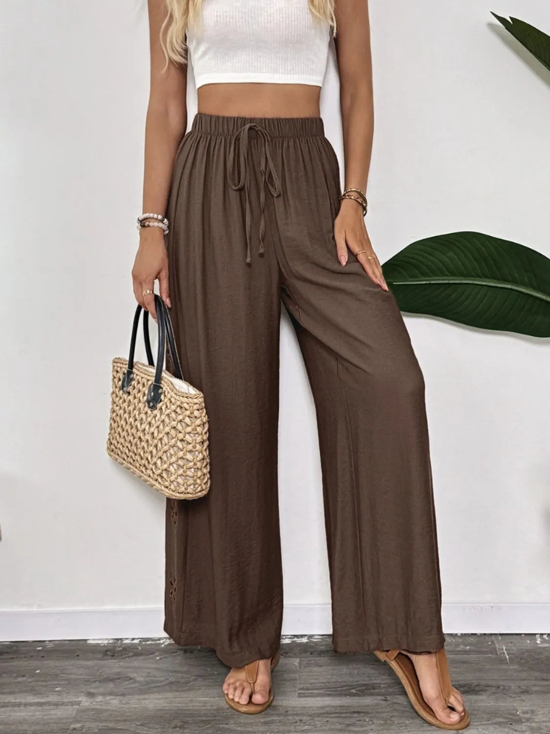 Dark brown wide-leg pants with drawstring waist and loose straight legs