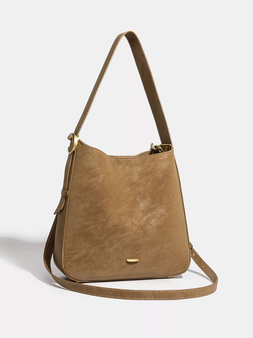 Brown faux leather shoulder bag with adjustable strap and gold-tone hardware.