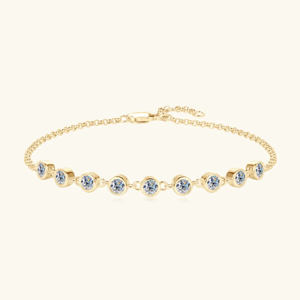 Gold-tone tennis bracelet with evenly spaced round blue stones and clasp