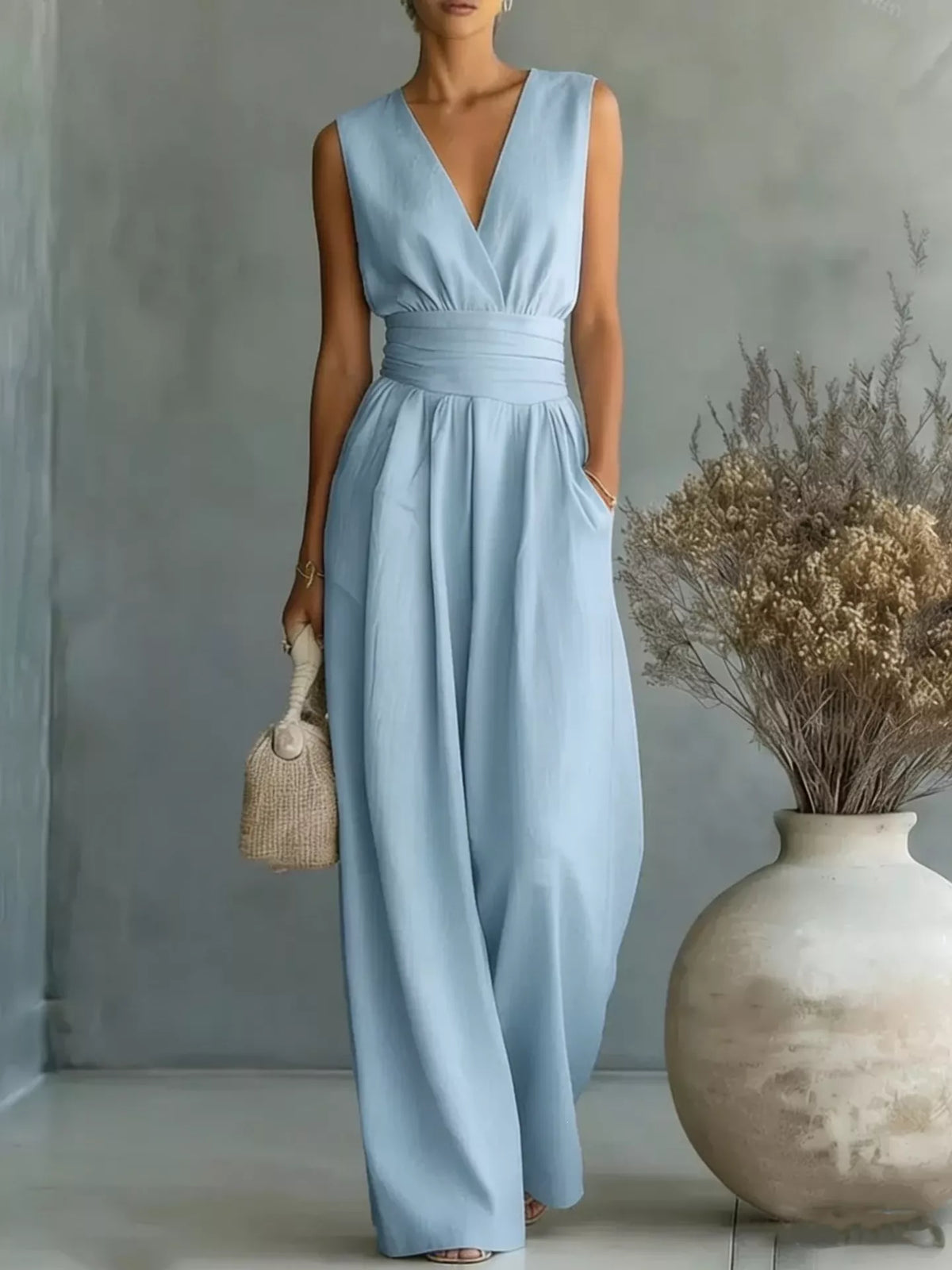 Sky blue sleeveless wide-leg jumpsuit with V-neck wrap bodice and gathered waist