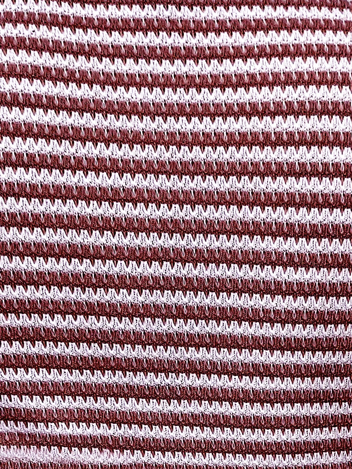 Close-up of burgundy-and-white striped knit tank top fabric