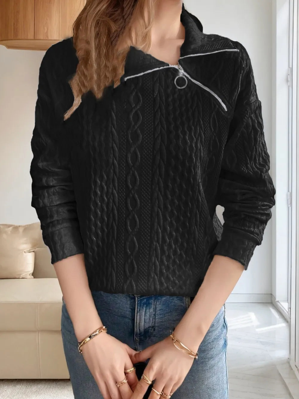 Black long-sleeve sweatshirt with collared neck and diagonal zipper detail, textured knit