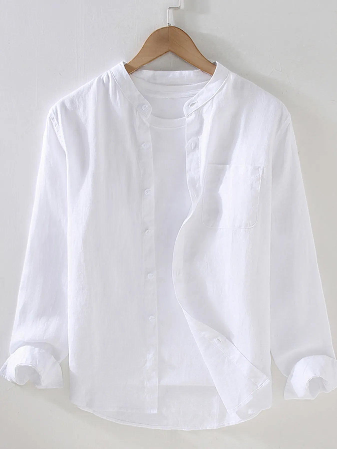Men's long sleeve button-up shirt in white with front buttons and chest pocket