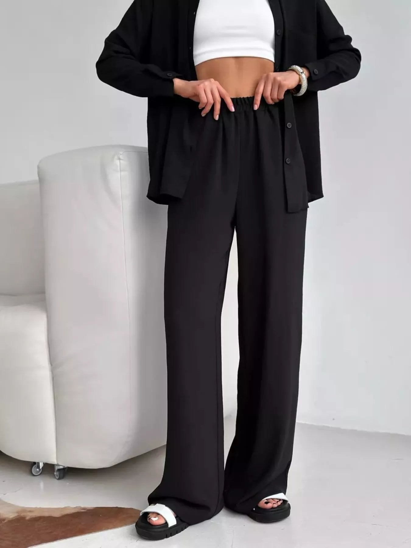 Black relaxed-fit shirt and wide-leg pants set, cropped view showing wide-leg hems