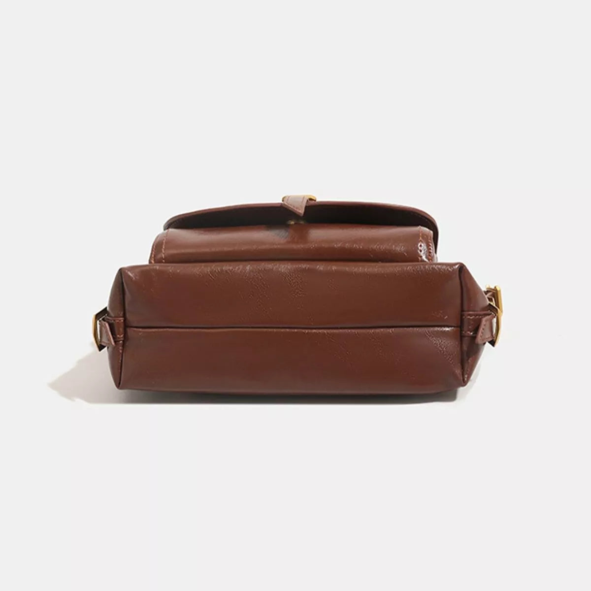 Caramel vegan leather shoulder bag back view with structured base and gold-tone hardware