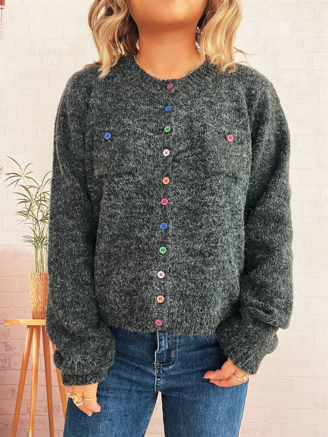 Dark gray button-up cardigan with chest pockets and multicolor button front, crew neck