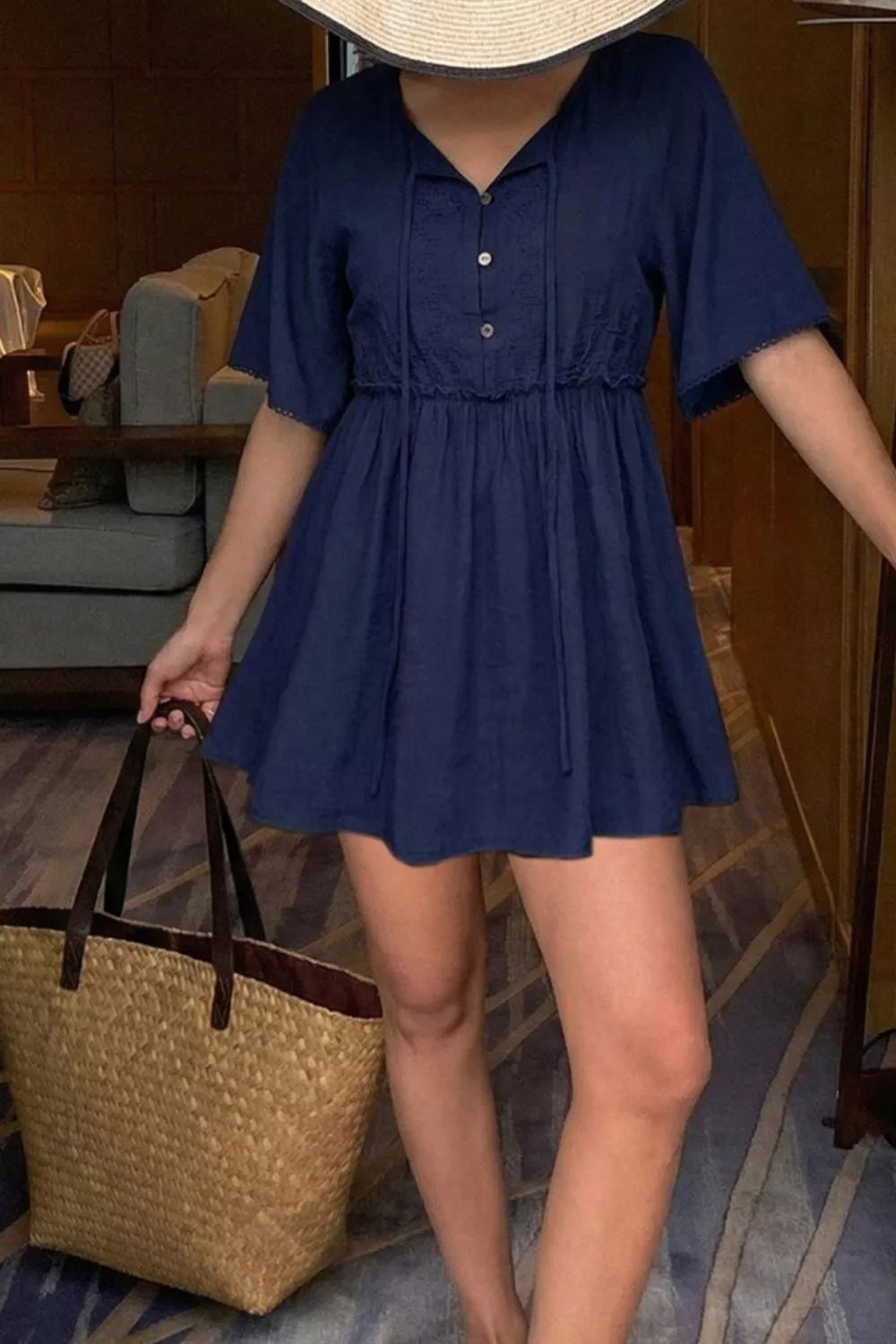 Ruffle Hem Tie Neck Blouse in navy blue with buttoned front.