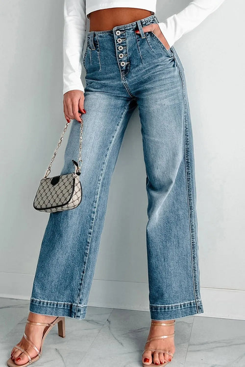 High-waist medium-blue button-fly jeans with wide legs and front button details