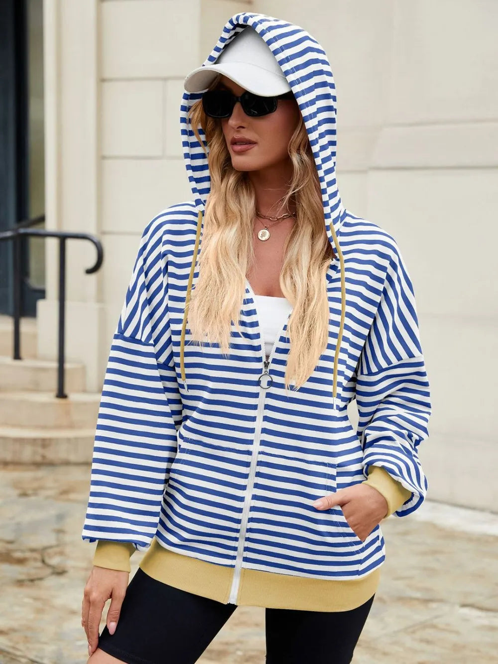 Blue and white striped zip-up hoodie with drawstring hood and long sleeves