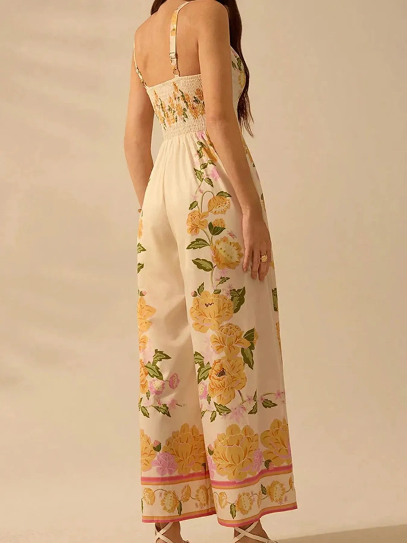 Cream floral wide-leg cami jumpsuit with open back V straps and gathered waist
