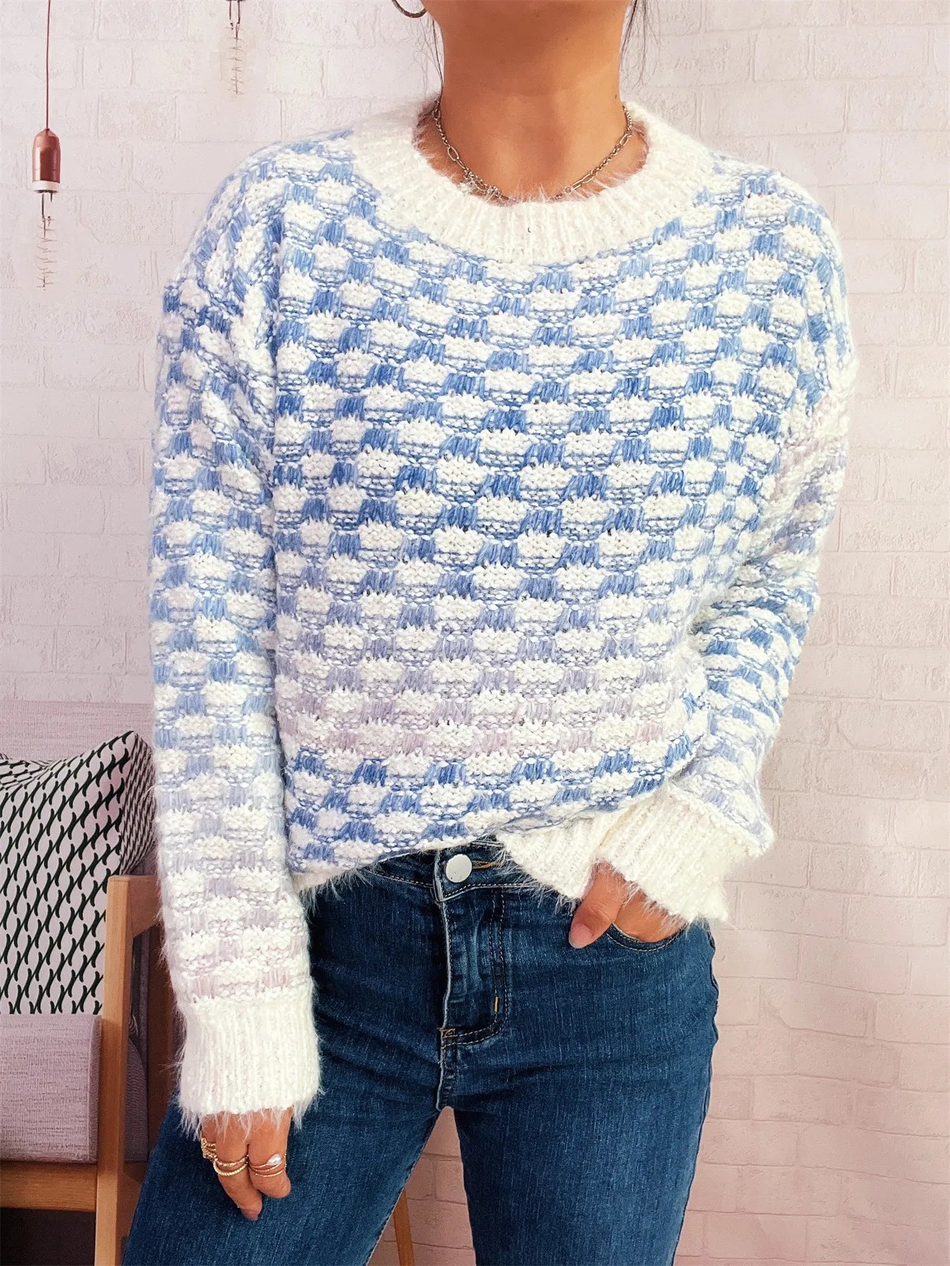 Light blue textured knit sweater with crew neck, long sleeves, ribbed cuffs and hem