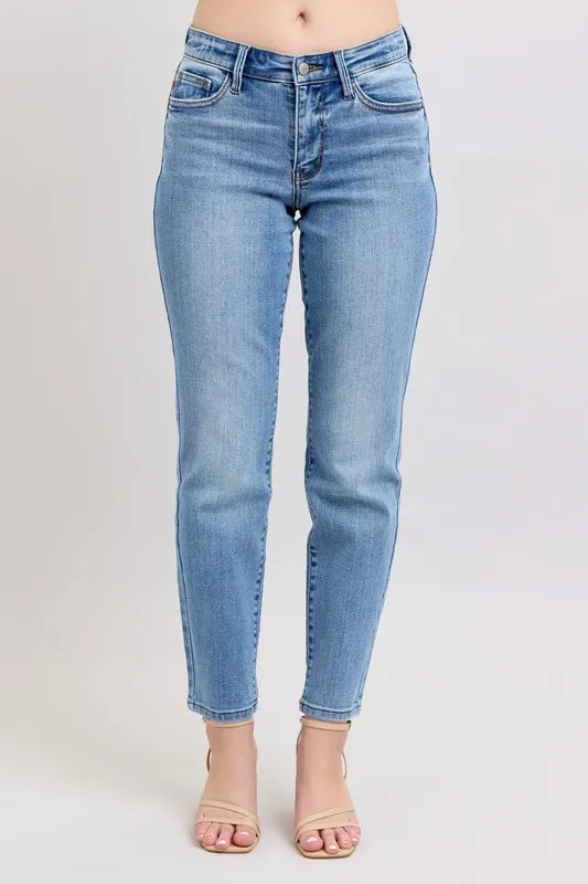 Light blue slim jeans with vintage wash, mid-rise waist, and cropped ankle hem
