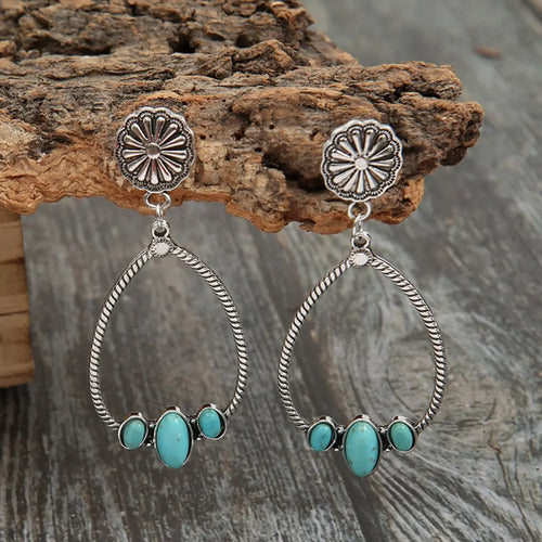 Silver teardrop hoop earrings with turquoise oval stones and embossed flower studs