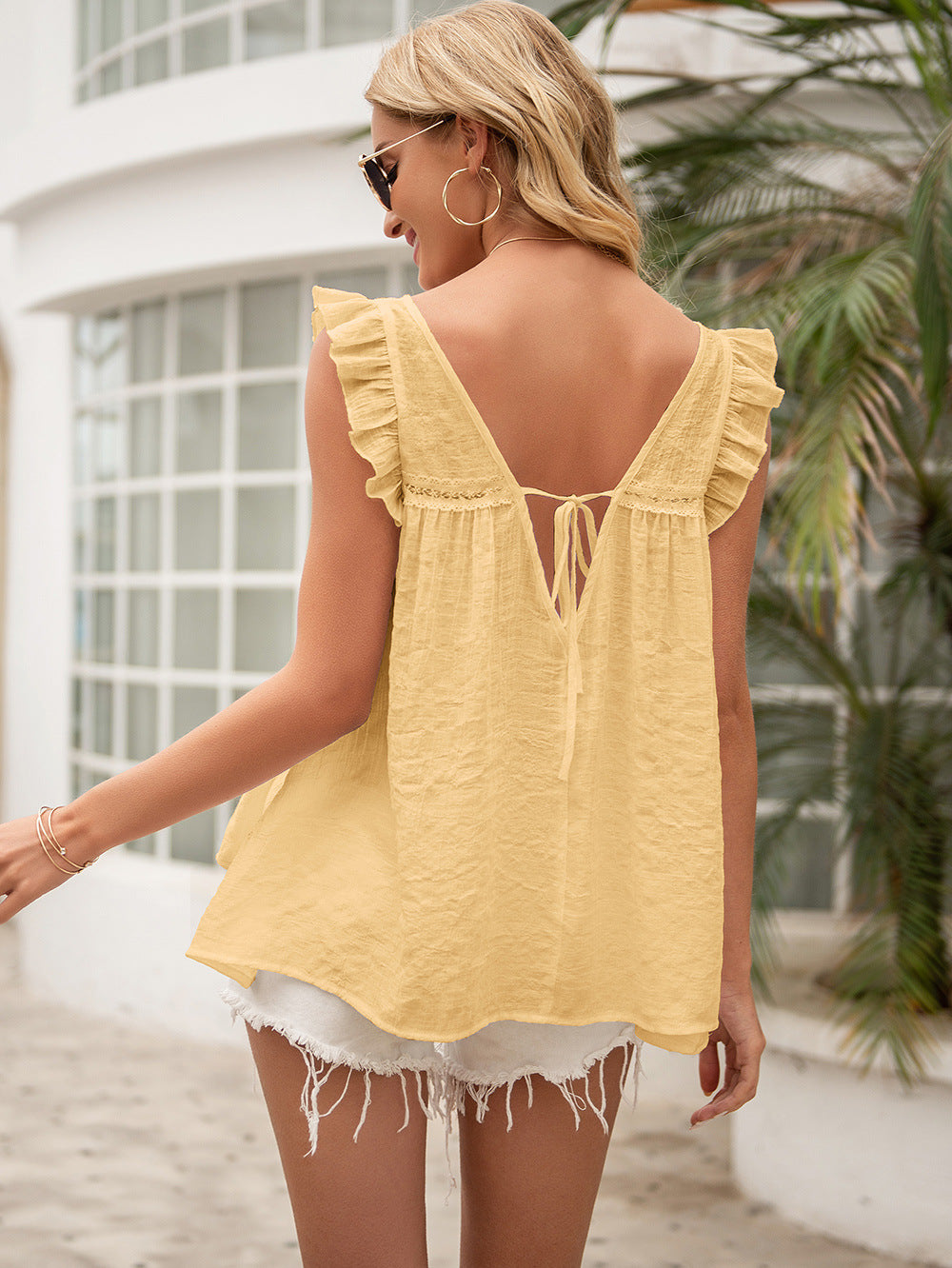 Light yellow ruffled backless tie-back blouse with flutter sleeves
