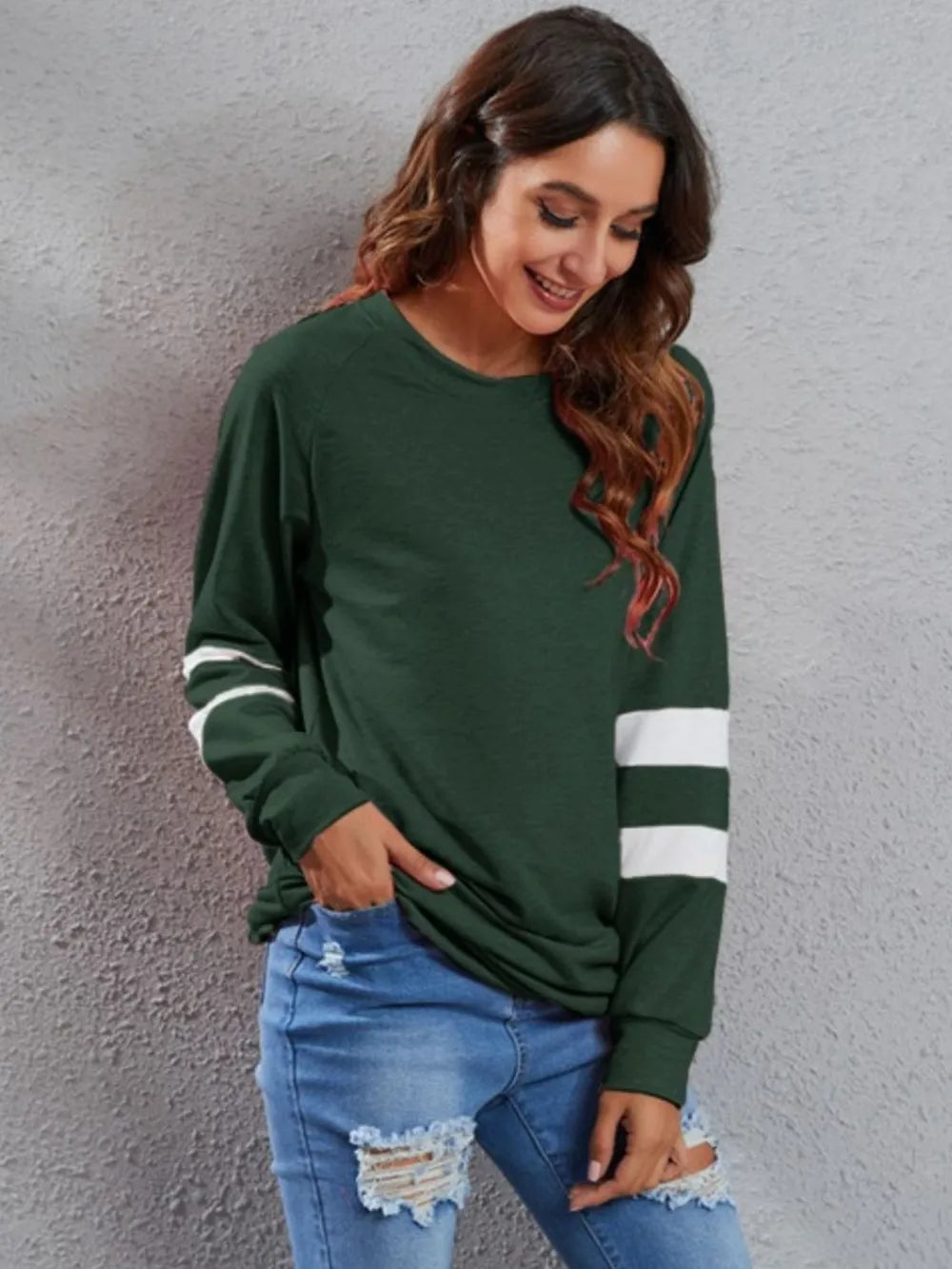 Dark green long-sleeve T-shirt with round neck and white striped sleeve accents