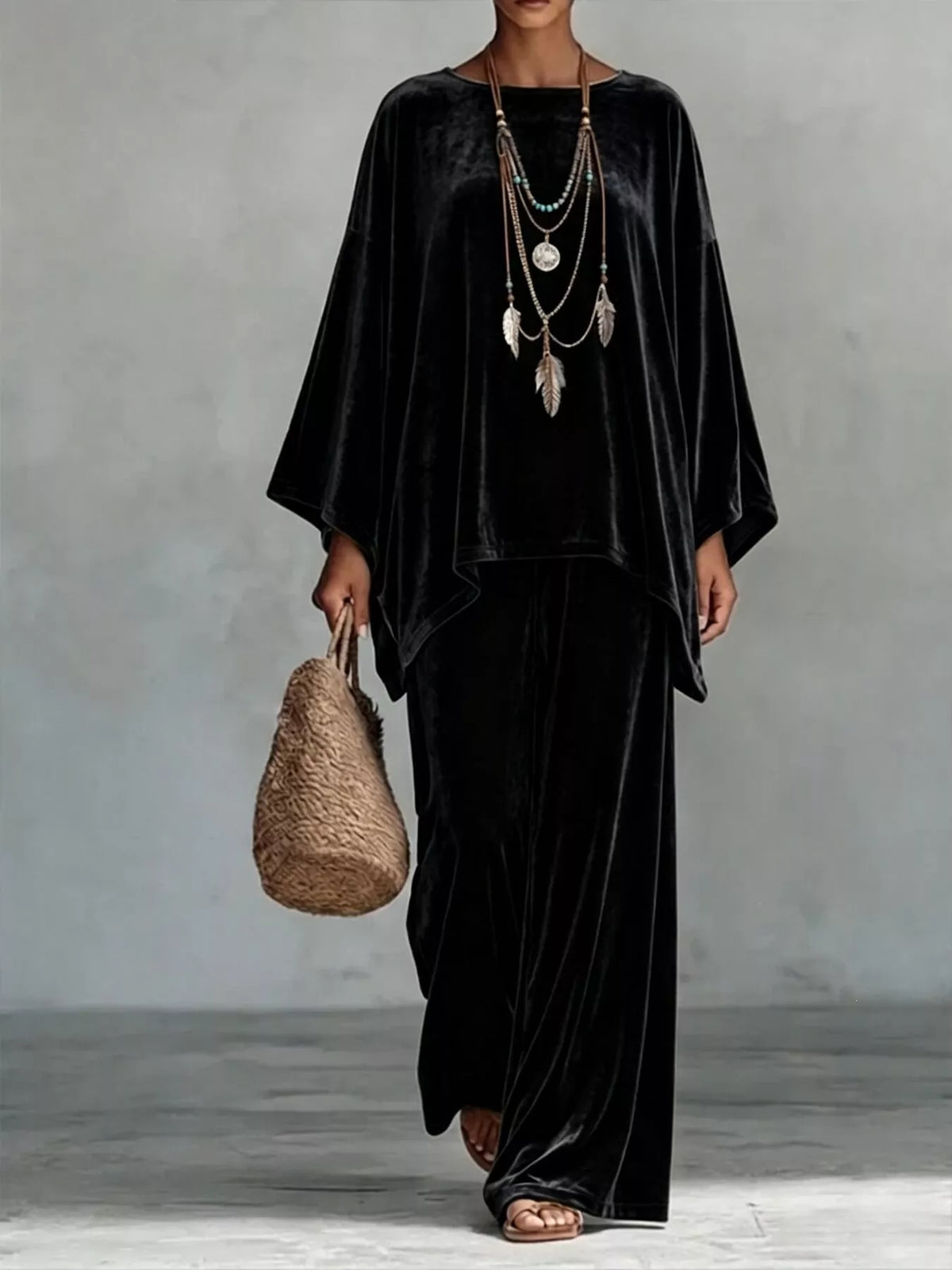 Black velvet wide-leg pants set with loose asymmetrical poncho-style top