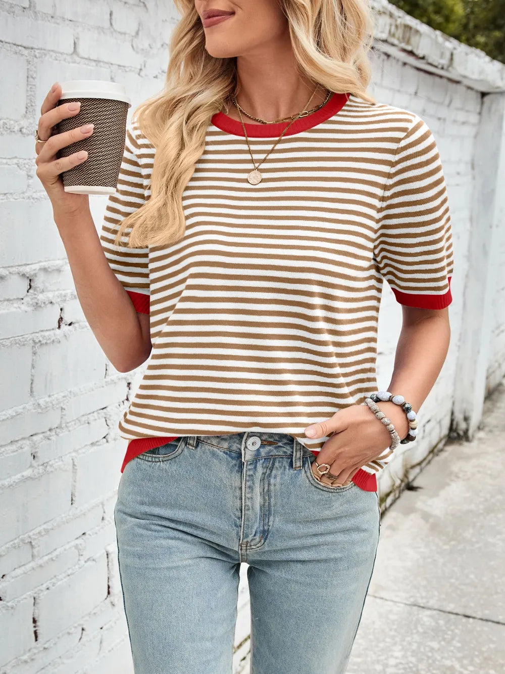 Black-and-white striped knit top with red contrast crew neck and ribbed sleeve trim