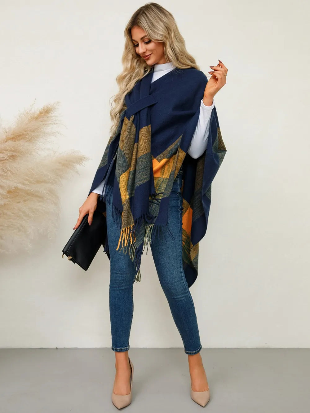 Fringe plaid poncho in navy with olive and gold stripe pattern and long tassel fringe