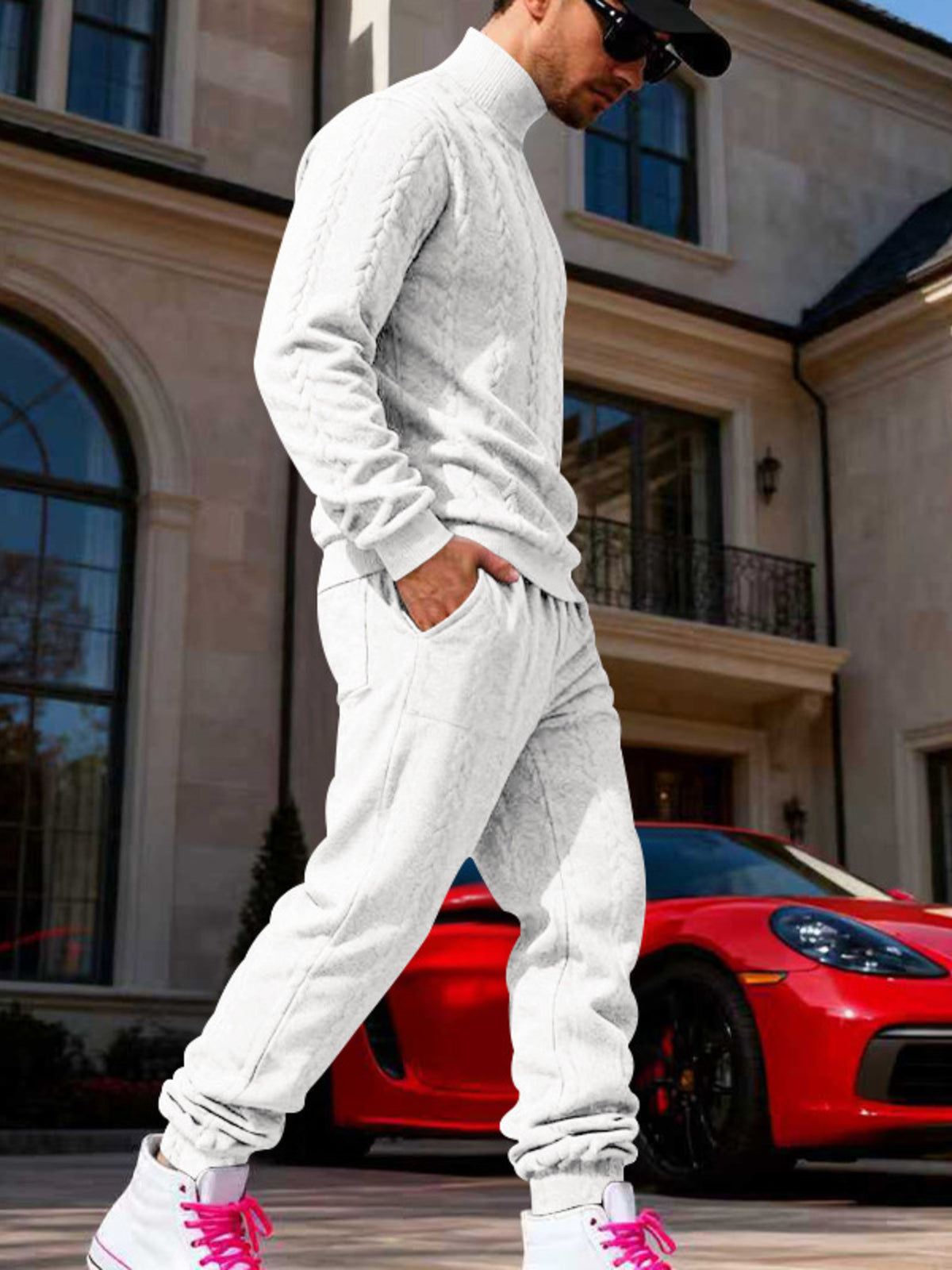 Men's white cable knit mock neck sweater with matching jogger pants, side profile