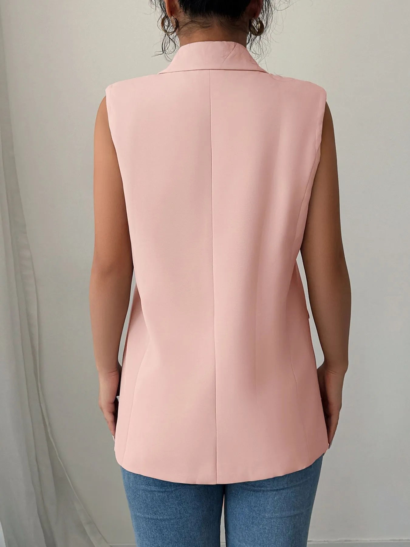 Back view of pale blush sleeveless blazer with center back seam