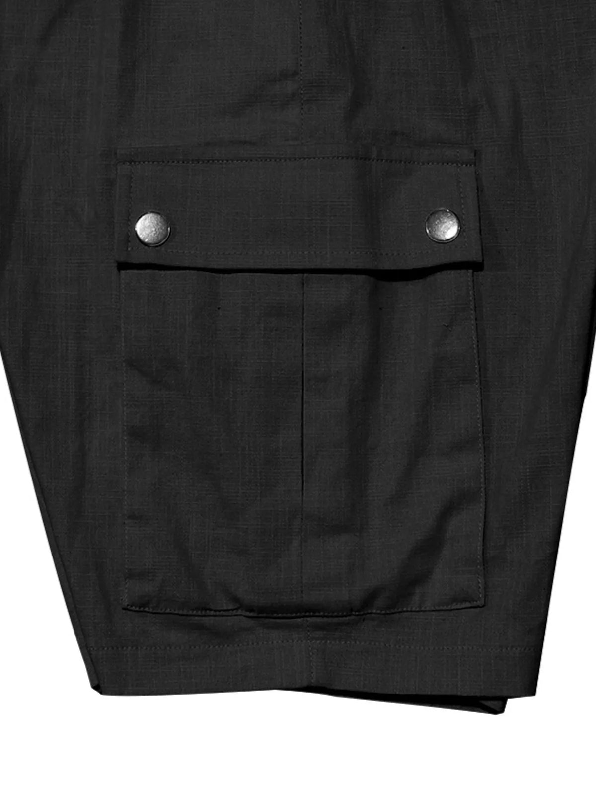 Black cargo shorts close-up: front flap pocket with snap buttons