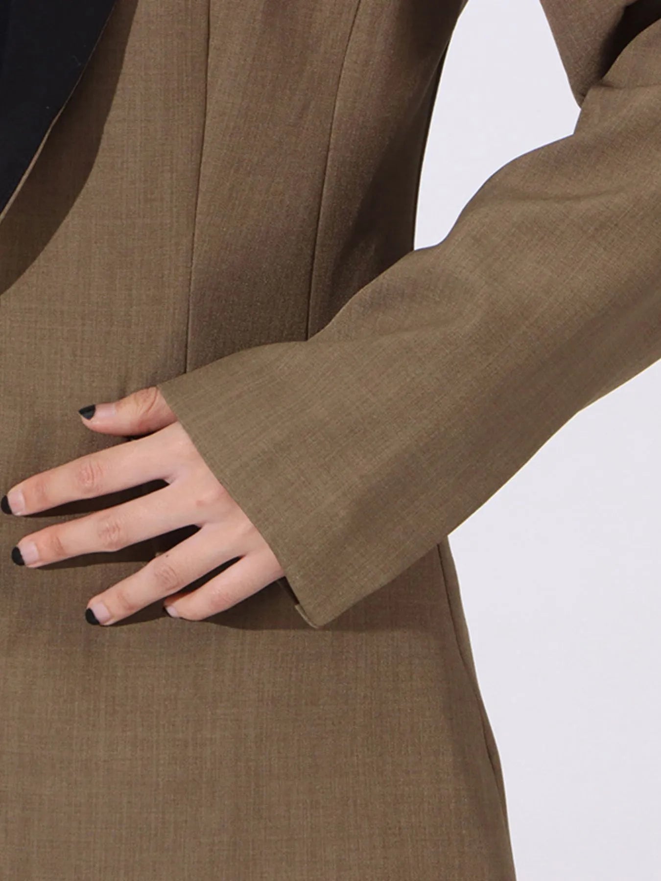 Khaki green blazer sleeve and cuff detail with tailored seam at forearm