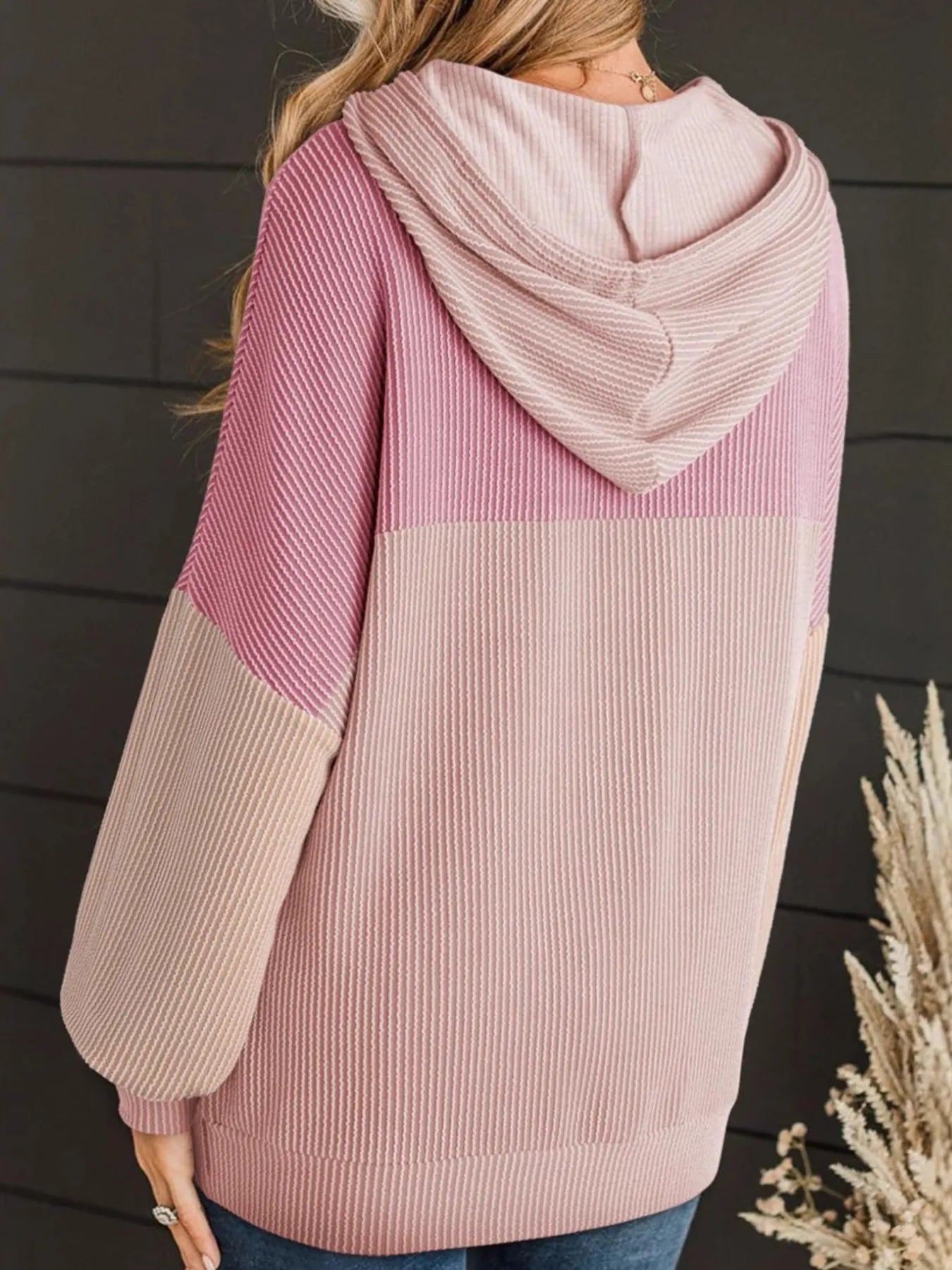 Color block long sleeve hoodie in pink and cream, striped knit, drawstring hood, front pocket