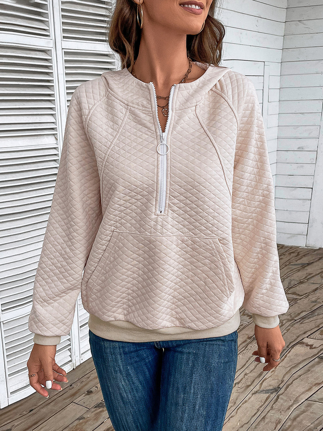 Cream quilted half-zip hoodie with hood and front pocket, long sleeves