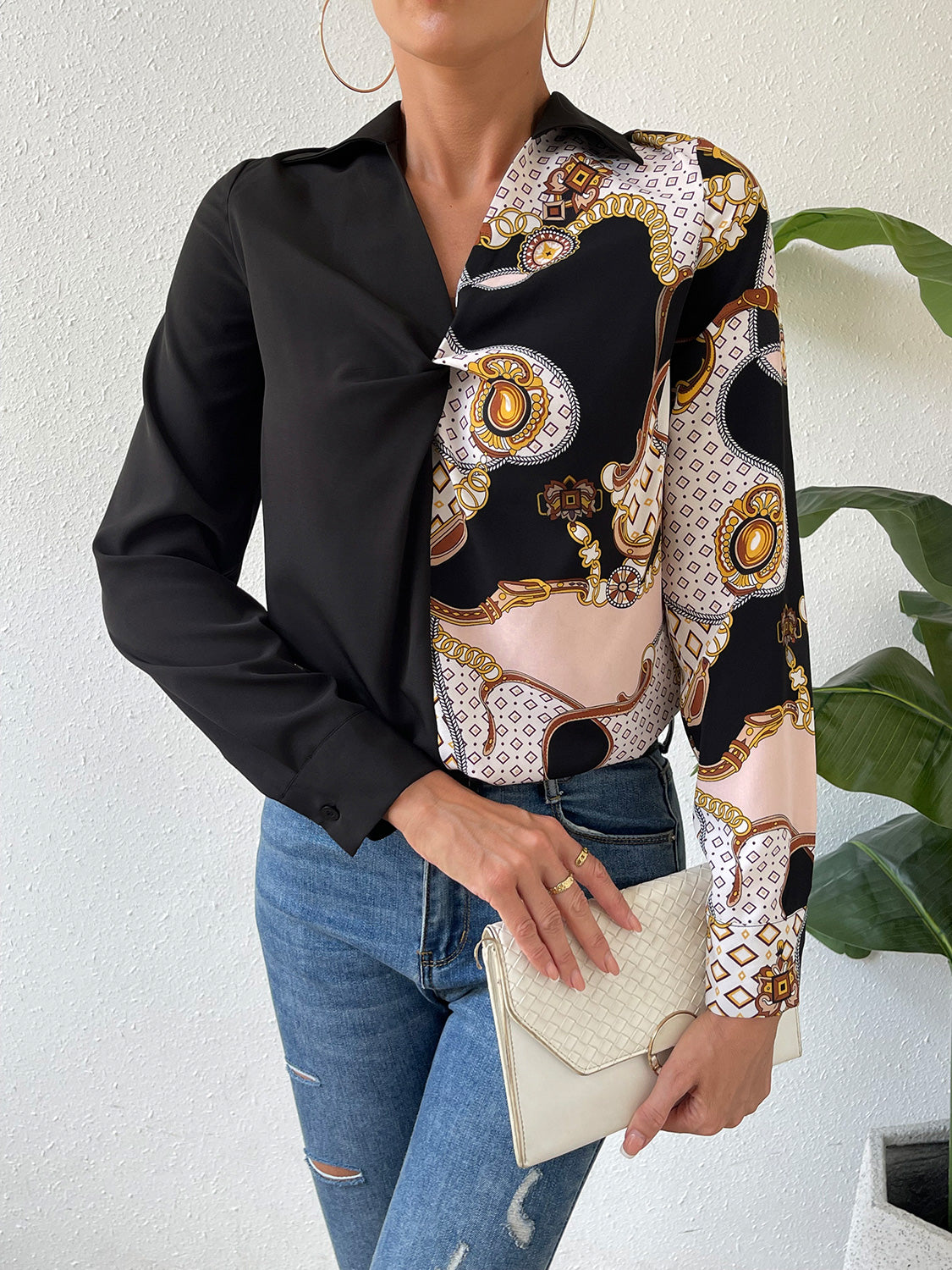 Black twist-front collared blouse with collared neckline and patterned long sleeve panel