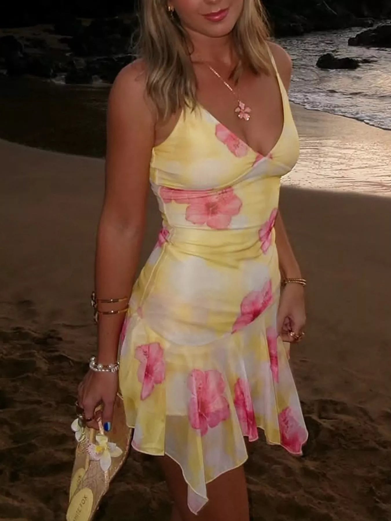 Yellow sheer sleeveless mini dress with pink floral print and asymmetrical ruffled hem