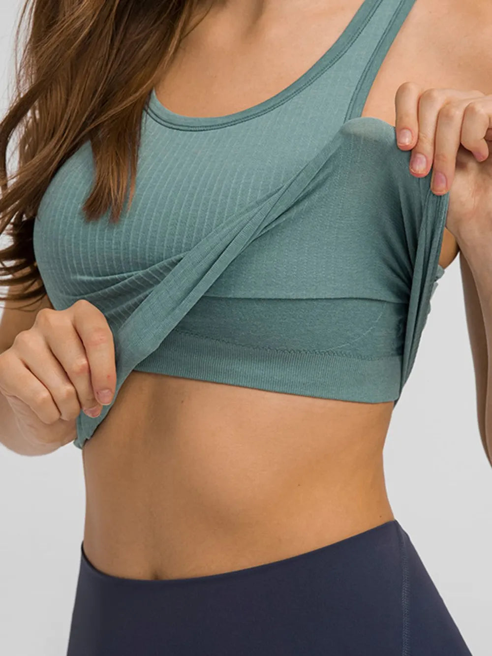 Turquoise active tank top with round neck and racerback straps for workout wear.