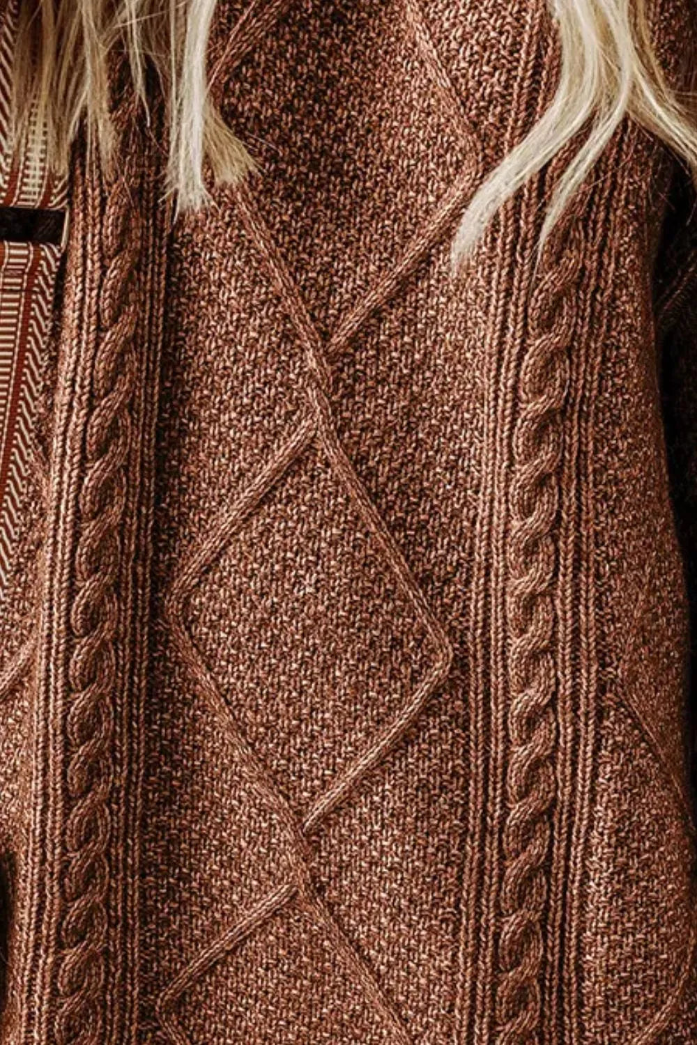 Brown cable-knit sweater dress close-up with diamond motif and vertical rope cables